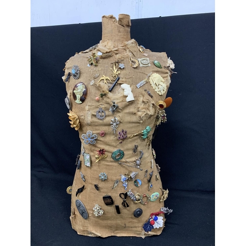 540 - Half mannequin with costume brooches, height 77cms