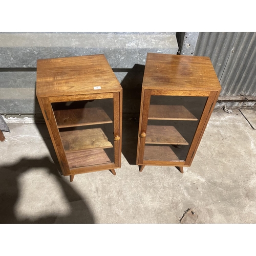 6 - A pair of teak glazed cabinets with splayed teak legs