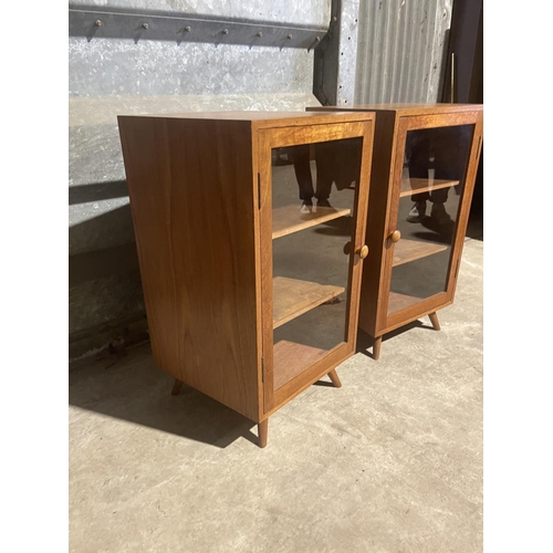 6 - A pair of teak glazed cabinets with splayed teak legs