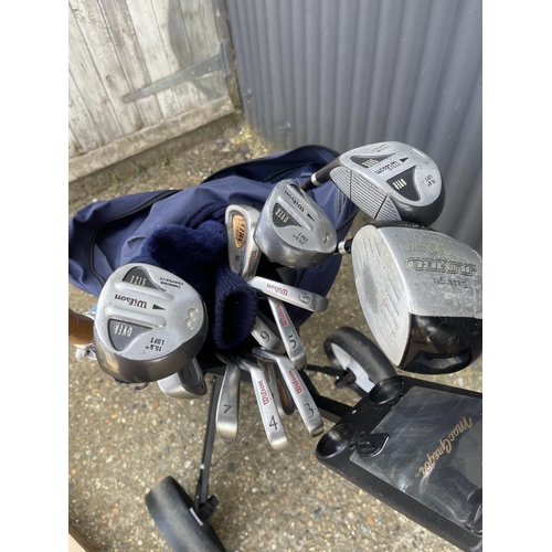 60 - A Golf trolley loaded with set of wilson golf clubs toghter with a boxed set of Taylor made golf clu... 