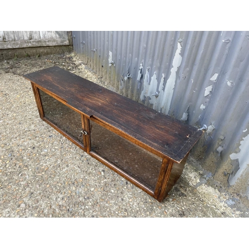 68 - A glazed oak two door cabinet