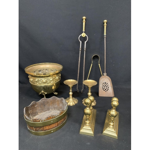 686 - Large brass bucket, companion set, fire dogs, 2 heavy candle holders, oak basket with brass straps