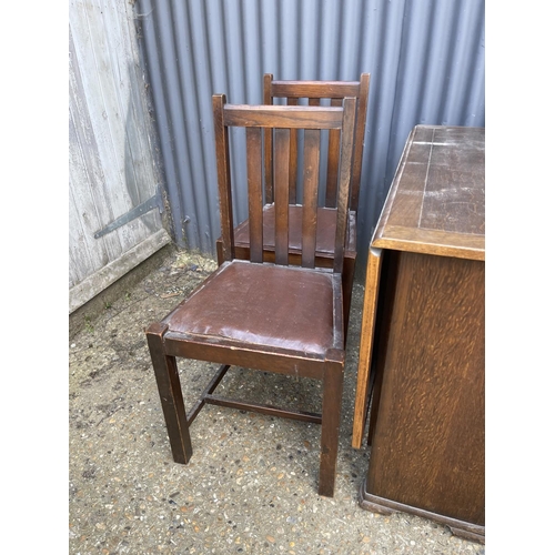 72 - A ealry 20th century oak drop leaf table together with four chairs