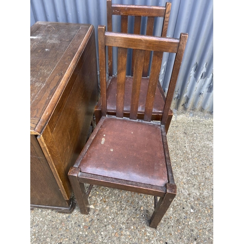 72 - A ealry 20th century oak drop leaf table together with four chairs