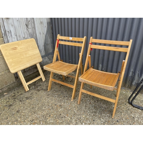 87 - Two folding chairs and a table