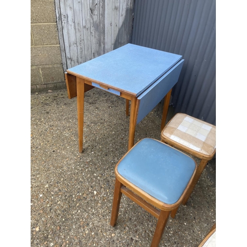 9 - A formica kitchen table together with four stools