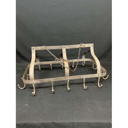 923 - Hanging iron game rack with 16 hooks