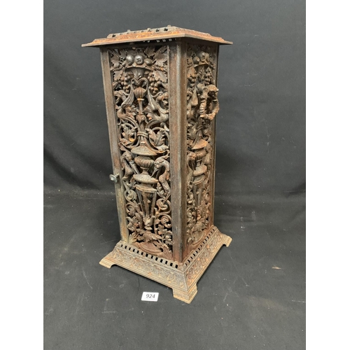 924 - An ornate cast iron stove cover height 58 cms base 29 x 29 cms (slight damage to base of rear panel)