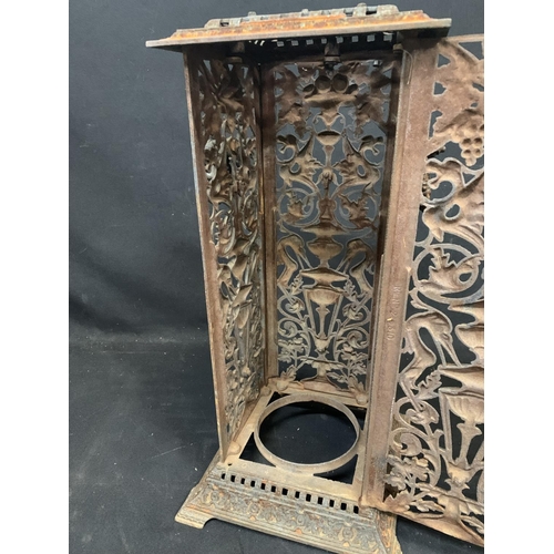 924 - An ornate cast iron stove cover height 58 cms base 29 x 29 cms (slight damage to base of rear panel)