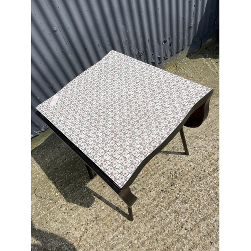 94 - A formica drop leaf kitchen table with patterned top