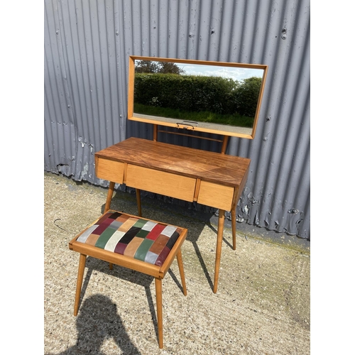 99 - AN unusual mid century teak three drawer dressing table / desk together with stool