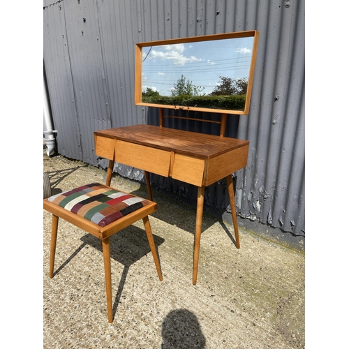 99 - AN unusual mid century teak three drawer dressing table / desk together with stool