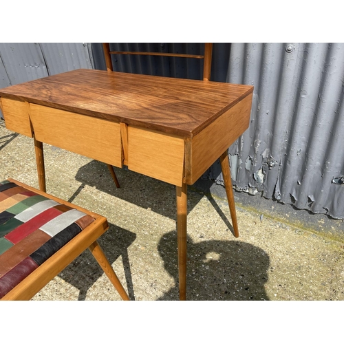 99 - AN unusual mid century teak three drawer dressing table / desk together with stool