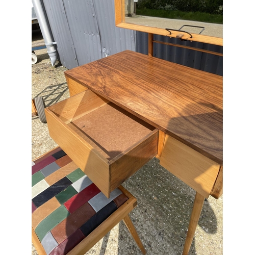 99 - AN unusual mid century teak three drawer dressing table / desk together with stool