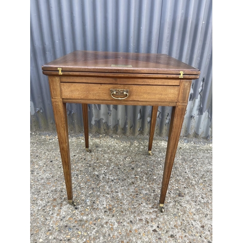 104 - An Edwardian mahogany envelope card table with presentation plaque 55x55x 75