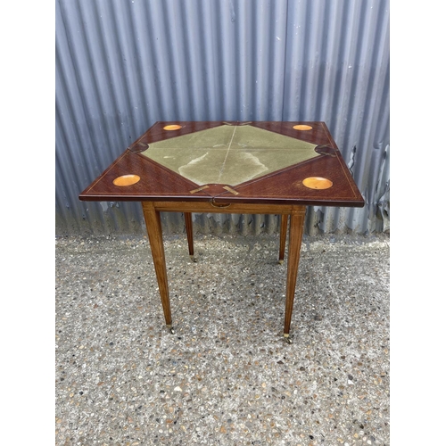 104 - An Edwardian mahogany envelope card table with presentation plaque 55x55x 75