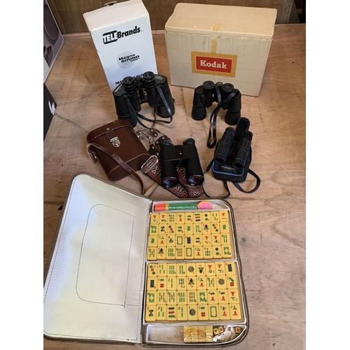 1051 - Four pairs of binoculars, projector, headphones and mahjong set