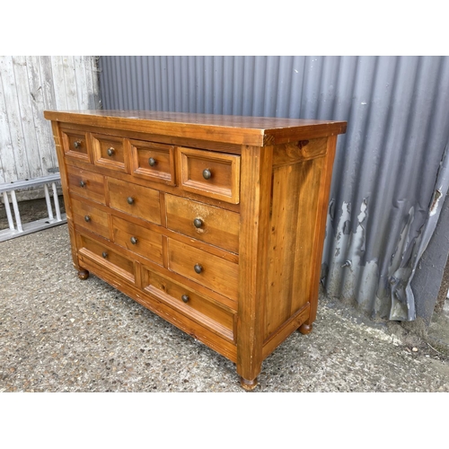 12 - A modern solid pine chest of 12 drawers