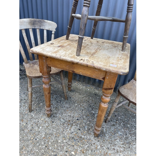 17 - A small square pine kitchen table together with three assorted kitchen chairs