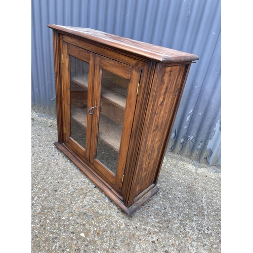 19 - A glazed pine two door cabinet 90x30x95