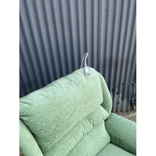 3 - A green upholstered Electric rise and recline armchair with reading light