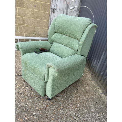 3 - A green upholstered Electric rise and recline armchair with reading light