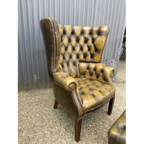 40 - A antique green leather chesterfield barrelled back armchair together with matching footstool