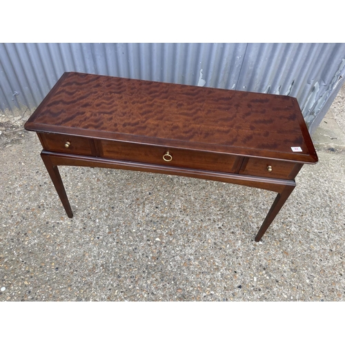 45 - A stag minstrel three drawer writing table 120x40x77