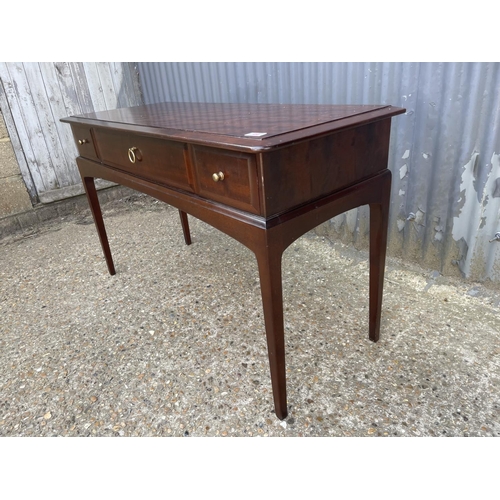 45 - A stag minstrel three drawer writing table 120x40x77