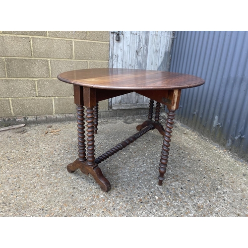 49 - A early 20th century barley twist teak gate leg table 117 diameter 77 high