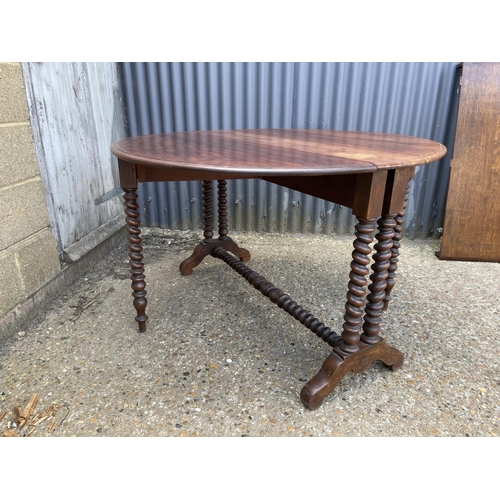 49 - A early 20th century barley twist teak gate leg table 117 diameter 77 high