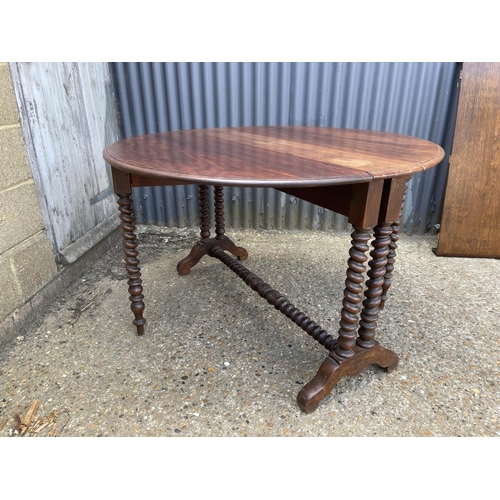 49 - A early 20th century barley twist teak gate leg table 117 diameter 77 high