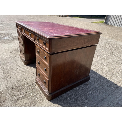 5 - A Victorian mahogany twin pedestal desk with a red leather top