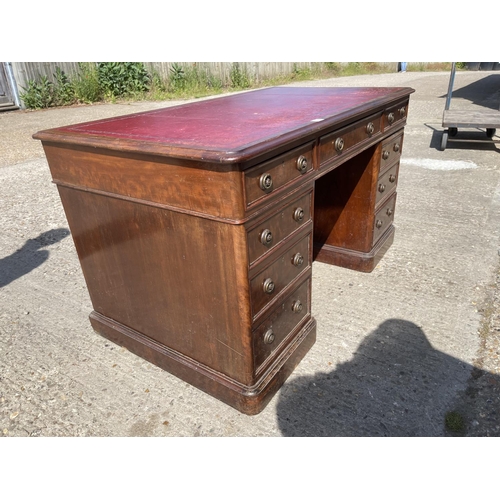 5 - A Victorian mahogany twin pedestal desk with a red leather top