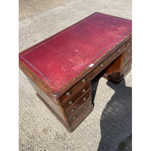 5 - A Victorian mahogany twin pedestal desk with a red leather top