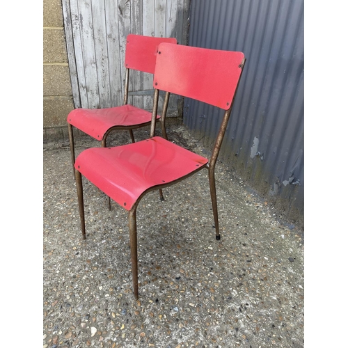 50 - A pair of vintage red formica and metal frame stacker chairs