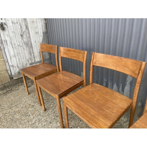 53 - A set of four mid century teak style stacking chairs