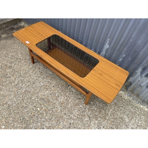 54 - A mid century schreiber teak effect coffee table with smoked glass top