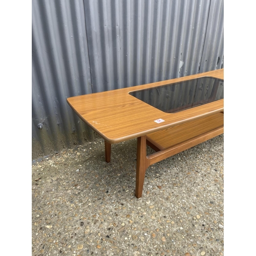 54 - A mid century schreiber teak effect coffee table with smoked glass top