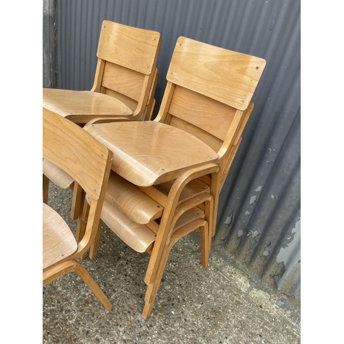 57 - Seven bent ply stacking chairs