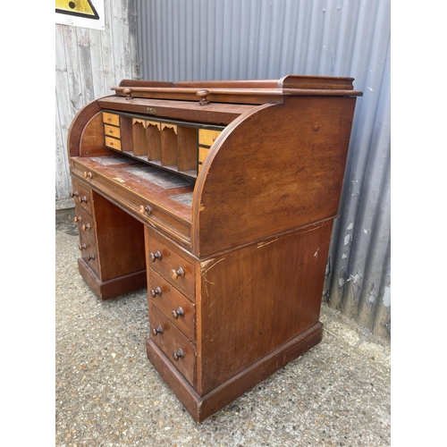 67 - A Victorian mahogany twin pedestal desk with cylinder top, revealing a satinwood fitted interior and... 