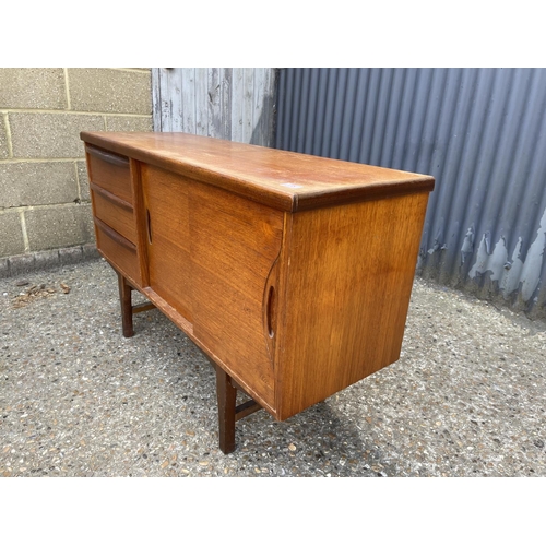 75 - A mid century compact sized teak sideboard  120x 40x75