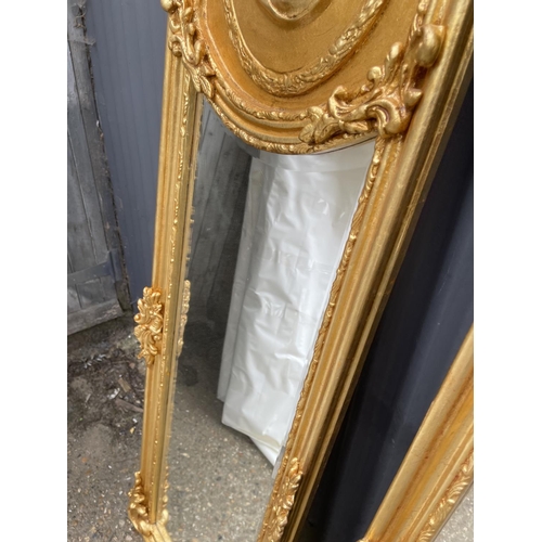 110 - A pair of large ornate gold gilt mirrors decorated with ladies facing each other 180x50 each