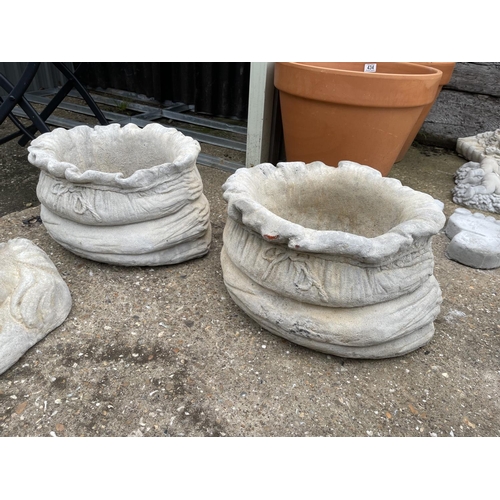 113 - A pair of large concrete sack effect planters