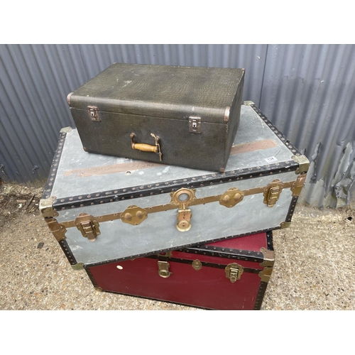 134 - Two large vintage travelling trunks and a case