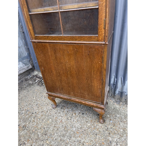 14 - An oak two door glazed cabinet 60x30x 160