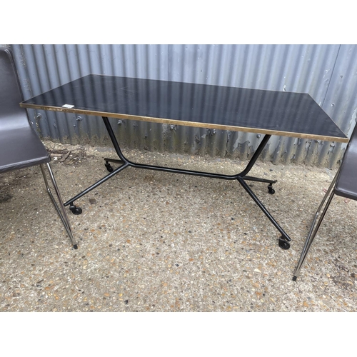 141 - A modern black trolley table together with two black leather and chrome chairs