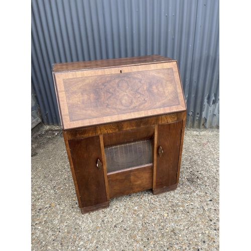 147 - A walnut Art Deco HMV radiogram with speakers enclosed in a bureau