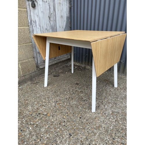 151 - A modern light oak drop leaf table together with glass top kitchen table