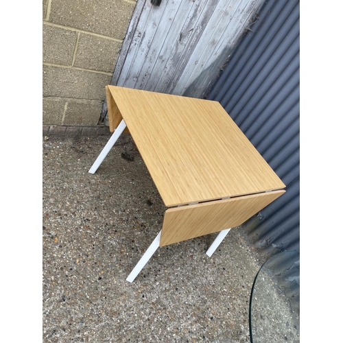 151 - A modern light oak drop leaf table together with glass top kitchen table